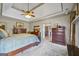 Beautiful main bedroom with trey ceilings, ceiling fan, access to bathroom, and neutral carpeting at 50 Red River Ct, Covington, GA 30014