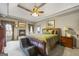 Bright main bedroom features a cozy fireplace, trey ceilings with a ceiling fan, and neutral carpeting at 50 Red River Ct, Covington, GA 30014