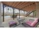 Relaxing outdoor patio with comfortable seating overlooking a pool and a wooden pergola at 50 Red River Ct, Covington, GA 30014