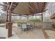 Picturesque pergola with comfortable seating, perfect for enjoying outdoor living in a beautifully landscaped yard at 50 Red River Ct, Covington, GA 30014