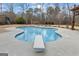 A bright in-ground pool with surrounding patio provides the perfect backyard oasis at 50 Red River Ct, Covington, GA 30014