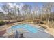 A refreshing backyard pool with a diving board, lounge chairs, and a pergola seating area at 50 Red River Ct, Covington, GA 30014