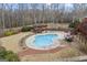 An aerial view captures the backyard's inviting pool, pergola, and patio at 50 Red River Ct, Covington, GA 30014