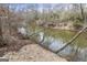 Scenic river view with sandy banks and mature trees at 50 Red River Ct, Covington, GA 30014