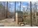 Backyard shed with green roof sitting on top of a unique base next to a creek at 50 Red River Ct, Covington, GA 30014