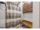 Modern shower features striped curtain, a built-in bench, and a storage cabinet at 50 Red River Ct, Covington, GA 30014