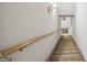 Carpeted staircase with wooden handrail leading to the next level of the house, offering a clear and safe passage at 50 Red River Ct, Covington, GA 30014