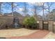 A soothing waterfall feature adds serenity to this backyard landscape with stone privacy wall at 50 Red River Ct, Covington, GA 30014