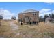Spacious backyard of a brick home with a patio, grill, and ample room for outdoor activities at 121 Amelia Way, Ellenwood, GA 30294