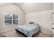 Bright bedroom with a vaulted ceiling and a large window, creating a cozy space at 121 Amelia Way, Ellenwood, GA 30294