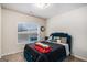 This bright bedroom has a large window, a comfortable bed, and cozy décor at 121 Amelia Way, Ellenwood, GA 30294