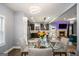 Dining room with a glass-topped table, chairs, and an open view into the kitchen and living area at 121 Amelia Way, Ellenwood, GA 30294