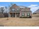 Beautiful two-story brick home with a covered porch and neat yard at 121 Amelia Way, Ellenwood, GA 30294