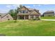 Charming brick home with a manicured lawn and inviting covered front porch at 121 Amelia Way, Ellenwood, GA 30294