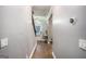 Hallway with wood floors, showing the front door and stairs at 121 Amelia Way, Ellenwood, GA 30294