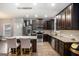 Well-equipped kitchen featuring granite countertops, stainless steel appliances, and stylish pendant lighting at 121 Amelia Way, Ellenwood, GA 30294