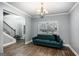 Cozy living room with a blue couch and modern light fixture at 121 Amelia Way, Ellenwood, GA 30294
