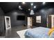 The spacious main bedroom is accented by dark walls, modern lighting, and dark wood flooring at 121 Amelia Way, Ellenwood, GA 30294