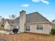Large backyard with a patio featuring a table and grill, with an expansive lawn at 506 Olivia Ct, Stockbridge, GA 30281