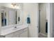 Bathroom with a large mirror, vanity with storage, and a shower at 506 Olivia Ct, Stockbridge, GA 30281