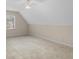 Bedroom with plush carpeting, neutral paint, window with blinds, and a sloped ceiling at 506 Olivia Ct, Stockbridge, GA 30281
