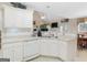 Bright kitchen with white cabinets and appliances, tile backsplash and breakfast bar at 506 Olivia Ct, Stockbridge, GA 30281