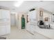Bright kitchen with white cabinets and appliances, tile backsplash and breakfast bar at 506 Olivia Ct, Stockbridge, GA 30281