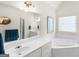 Main bathroom features a soaking tub, dual vanity and glass block window at 506 Olivia Ct, Stockbridge, GA 30281