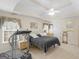 Bright main bedroom with a ceiling fan, tray ceiling, and neutral walls at 506 Olivia Ct, Stockbridge, GA 30281