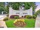 View of the Lenox Heights Condominiums community sign surrounded by manicured landscaping and lush trees at 2119 Pine Heights Ne Dr, Atlanta, GA 30324