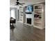 Cozy living room area with neutral paint, wood floors, built-in shelving, and a fireplace at 2119 Pine Heights Ne Dr, Atlanta, GA 30324