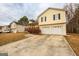 Two-story home with a front-facing two-car garage and covered front porch, providing curb appeal at 417 River Trace Dr, Villa Rica, GA 30180