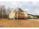 View of the home showing the covered front porch, side yard, and architectural details at 417 River Trace Dr, Villa Rica, GA 30180