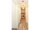 Hallway featuring wood-look flooring, white doors and a decorative light fixture at 417 River Trace Dr, Villa Rica, GA 30180