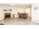 Well-lit living room featuring a stone fireplace, an adjacent dining area, and modern flooring at 417 River Trace Dr, Villa Rica, GA 30180