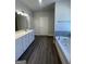 Modern bathroom boasts a double sink vanity with hard surface countertops, a soaking tub, and stylish plank flooring at 3392 Milan Ct # 2 Plapprox Sqft 3, Douglasville, GA 30135