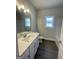 Well-lit bathroom features a sleek vanity with a white hard surface countertop and wood-look flooring at 3392 Milan Ct # 2 Plapprox Sqft 3, Douglasville, GA 30135