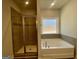 Elegant bathroom with a soaking tub, separate glass-enclosed shower, and tasteful tile accents at 3392 Milan Ct # 2 Plapprox Sqft 3, Douglasville, GA 30135