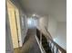 Hallway features wood-look flooring, a view of the living space, and a staircase with black metal balusters at 3392 Milan Ct # 2 Plapprox Sqft 3, Douglasville, GA 30135
