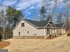 New home with a mixture of brick and tan siding on a sloping lot at 3392 Milan Ct # 2 Plapprox Sqft 3, Douglasville, GA 30135