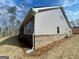 New home with gray siding and brick foundation on a sloping lot at 3392 Milan Ct # 2 Plapprox Sqft 3, Douglasville, GA 30135