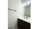 Bathroom with dark wood vanity, white countertop, and a decorative mirror at 2517 Oakleaf Rdg, Lithonia, GA 30058