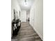 Hallway with wood-look floors, white walls, and an accent table with decor at 2517 Oakleaf Rdg, Lithonia, GA 30058