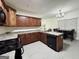 Kitchen featuring dark wood cabinets, granite countertops, and a dining area at 2517 Oakleaf Rdg, Lithonia, GA 30058