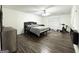 Spacious primary bedroom featuring sleek gray decor, ceiling fan, and laminate floors at 2517 Oakleaf Rdg, Lithonia, GA 30058