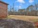 View of brick paver patio and backyard with mature trees and lawn at 445 Turner Dr, Mcdonough, GA 30252