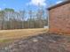 View of brick paver patio and backyard with mature trees and lawn at 445 Turner Dr, Mcdonough, GA 30252