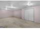 Spacious finished basement featuring carpet and a large closet with white doors at 445 Turner Dr, Mcdonough, GA 30252