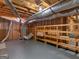 Unfinished basement showing exposed ductwork, plumbing, and wooden shelving at 445 Turner Dr, Mcdonough, GA 30252