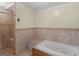 Neutral bathroom featuring a tile shower and tile surround soaking tub at 445 Turner Dr, Mcdonough, GA 30252